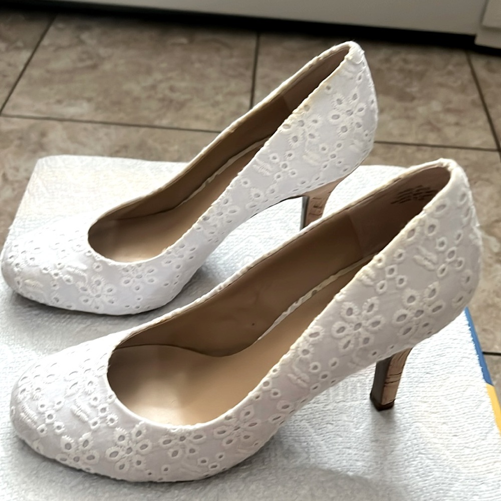 White eyelet pumps